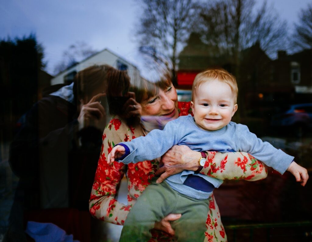 grandmother and baby at a window