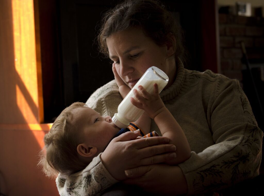 mother bottle feeding baby