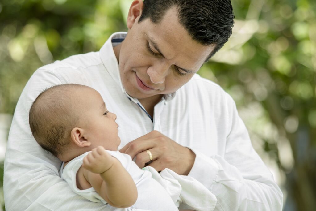 father looking at baby face to face
